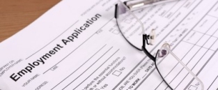Apprenticeship application form and pair of glasses