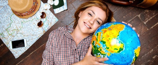 Girl holding up globe